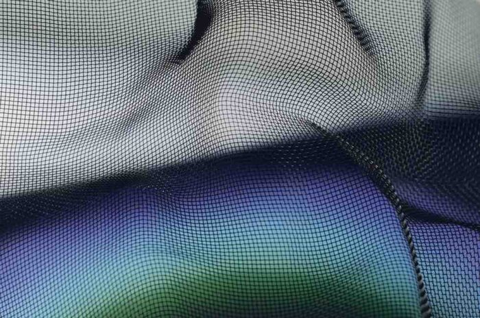 Close-up of a blue and green mesh fabric, showcasing its intricate weave and texture.