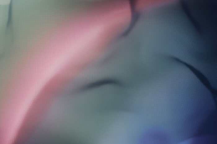 Blurry image featuring a soft blend of pink and blue hues in the background